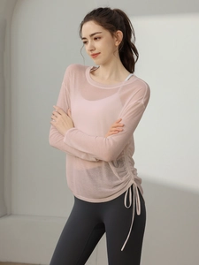 Women's light pink mesh long sleeve yoga top with adjustable side drawstring and ruched detail