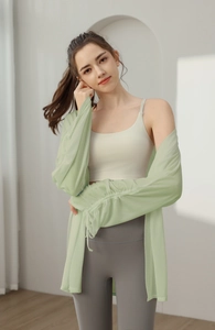 Detail view of adjustable drawstring cuffs on light green translucent yoga cover-up top