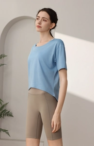 Detail of light blue quick-dry sports t-shirt and khaki high-waisted yoga shorts with pockets