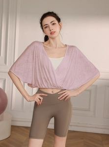 Close-up of pink jacquard nylon mesh yoga cover-up with breathable batwing sleeves
