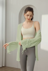Detail of light green yoga cover-up showing translucent fabric and drawstring cuffs