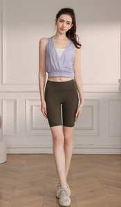 Detail view of nylon jacquard yoga top and green high-waist cycling shorts