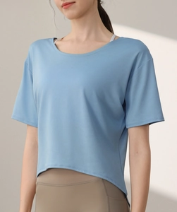 Detail of light blue quick-dry workout T-shirt showing breathable mesh texture and curved hem