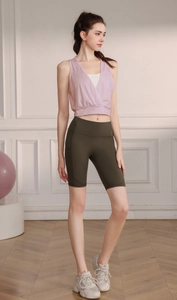 Detail of high-stretch jacquard yoga tank top with V-neck cross design for women