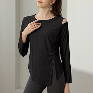 Women's black asymmetrical yoga top with shoulder cutout and side drawstring split hem