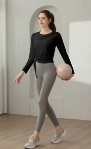 Detail showing the adjustable drawstring side tie on the slim-fit long sleeve sports top