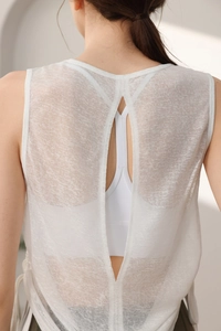 Detail of white mesh yoga top featuring breathable fabric and back slit design