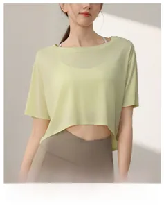 Detail of light yellow Tencel mesh workout crop top showing breathable fabric texture