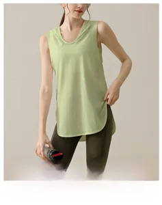 Detail of loose fit sleeveless yoga vest with side slit and breathable light green fabric