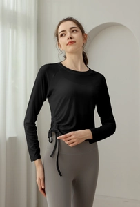 Slim fit black long sleeve yoga top featuring side drawstring details and a crew neck
