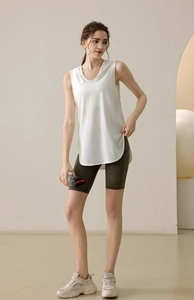 Relaxed fit white sleeveless yoga tank top with side slits and olive green biker shorts