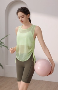 Detail of sheer mesh yoga tank top with adjustable side drawstrings and breathable fabric