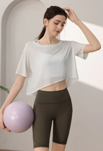 Detail of loose tencel sports cover-up with green high-waisted biker shorts on a model