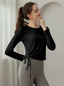 Slim fit black long sleeve yoga top with side drawstring details and round neckline
