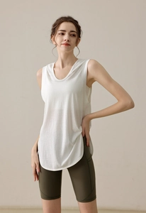 Detail view of white hooded sports vest with curved hem and olive green yoga shorts