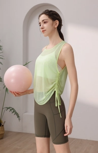 Detail view of breathable light green mesh yoga vest with adjustable side drawstring