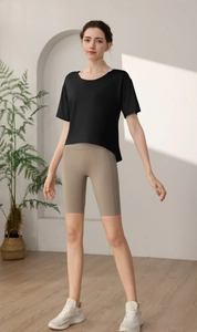 Detail of loose-fit black quick-dry workout t-shirt paired with high-waisted beige cycling shorts