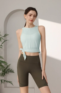 Detail des mintblauen Yoga-Tops mit Mesh-Schichten und modischem seitlichem Bindeknoten
