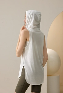 Detail view of white loose yoga hoodie tank top with side slits and breathable fabric