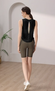 Close-up of women's black yoga tank top featuring a stylish teardrop open back design