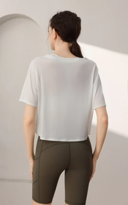 Macro detail of breathable white tencel sports crop top for yoga and fitness