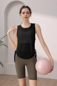Detail of black breathable mesh yoga tank top with side drawstring ties on model