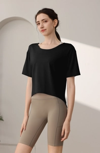 Detail view of women's camo burn-out loose sport t-shirt paired with brown yoga shorts