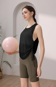 Detail view of women's yoga top with side drawstring and high-waist cycling shorts