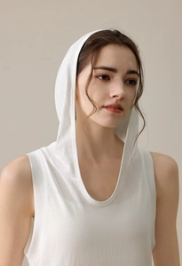 Detailed texture of white hooded sleeveless yoga vest featuring soft breathable knit fabric