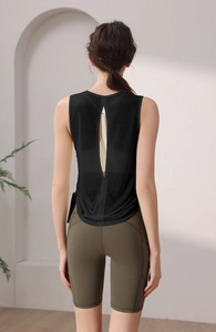 Back view of a black yoga tank top with vertical cutout and breathable mesh fabric