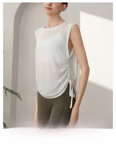 Detail of white yoga tank top showing side drawstring and breathable mesh texture