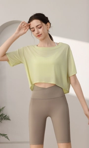 Detail of lime green tencel breathable mesh fabric and high-waist yoga shorts design