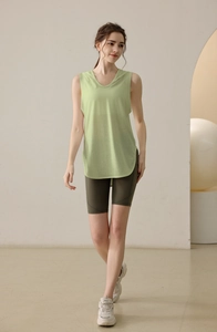 Close-up of light green loose hooded tank top and olive green high-waist yoga shorts set