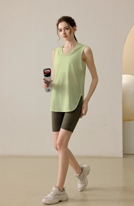 Detail of loose fit hooded vest with side slit and high waisted sports shorts with pocket