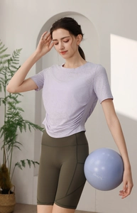 Détail du haut de yoga violet avec cordon de serrage et short de cyclisme à taille haute olive