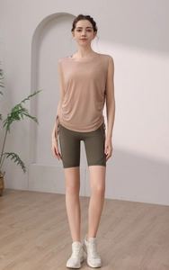 Detail of light brown workout tank top with side drawstring and olive green shorts