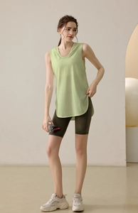 Close-up of light green loose gym vest showing knitting texture and large armhole detail