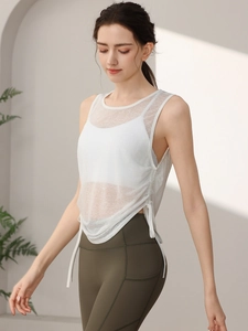 Women's white mesh yoga tank top with side drawstring and olive green high waist leggings