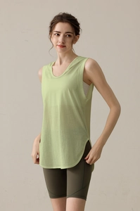 Detail of light green loose hooded sports vest with curved split hem for yoga
