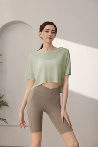 Detail of loose fit sage green yoga cover-up and high waist cycling shorts on model