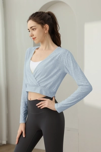 Detail of light blue jacquard long sleeve fitness top with breathable mesh texture