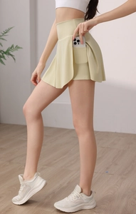 Détail d'une jupe-short de sport jaune pâle à taille haute avec poche intérieure pour téléphone
