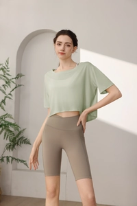 Macro view of light green loose yoga t-shirt and high waist shorts with side pocket