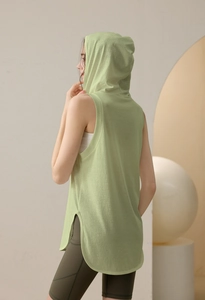 Detail of loose fit hooded yoga tank top in light green with breathable mesh fabric texture