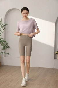 Detail of loose tencel sports top and cross waist yoga shorts with side pocket