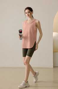 Detail of pink hooded sleeveless sports vest featuring side curve cut and soft fabric texture