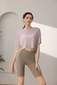 Detail of loose lavender yoga crop top paired with high waist olive fitness shorts