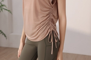 Close-up of the adjustable side drawstring and ruched texture on the pink yoga tank top