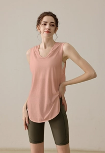 Pink orange sleeveless sports hoodie with olive green high-waisted yoga biker shorts