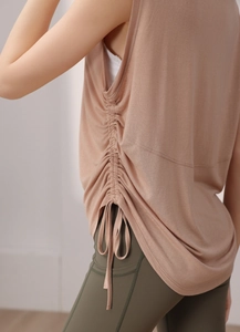 Detail of adjustable ruched side drawstring on oatmeal tencel yoga tank top
